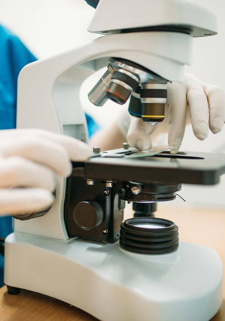 Doctor Putting Slide Under Microscope